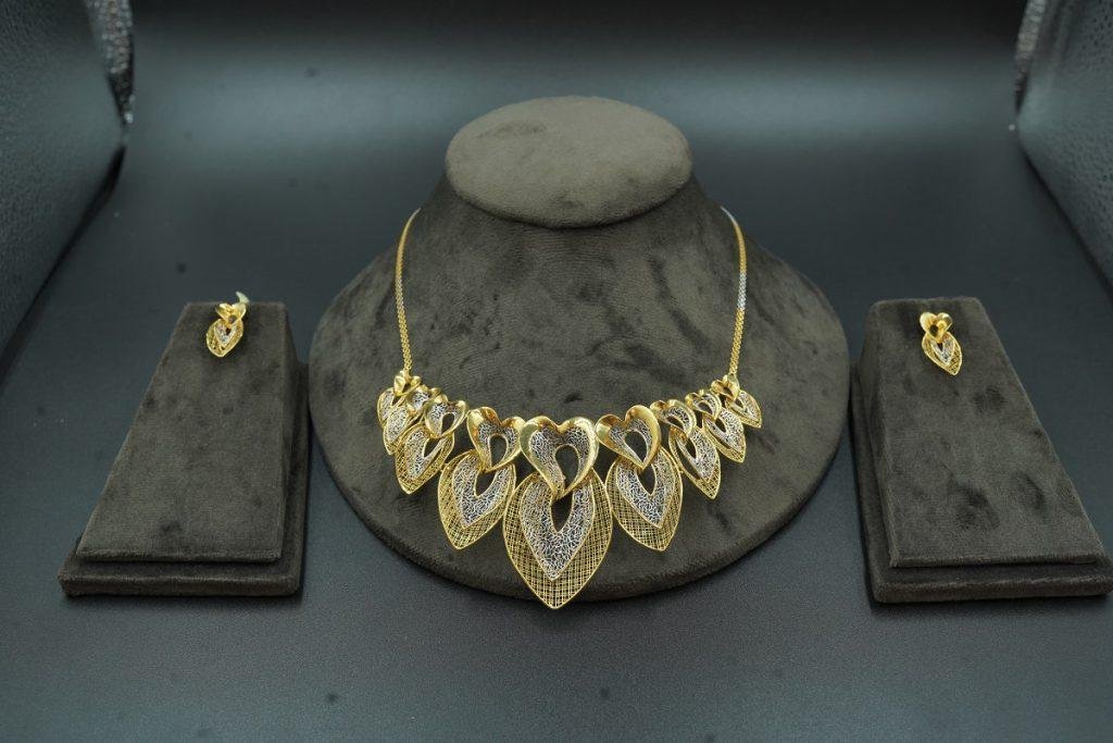 a unique multi heart shaped gold necklace and earings